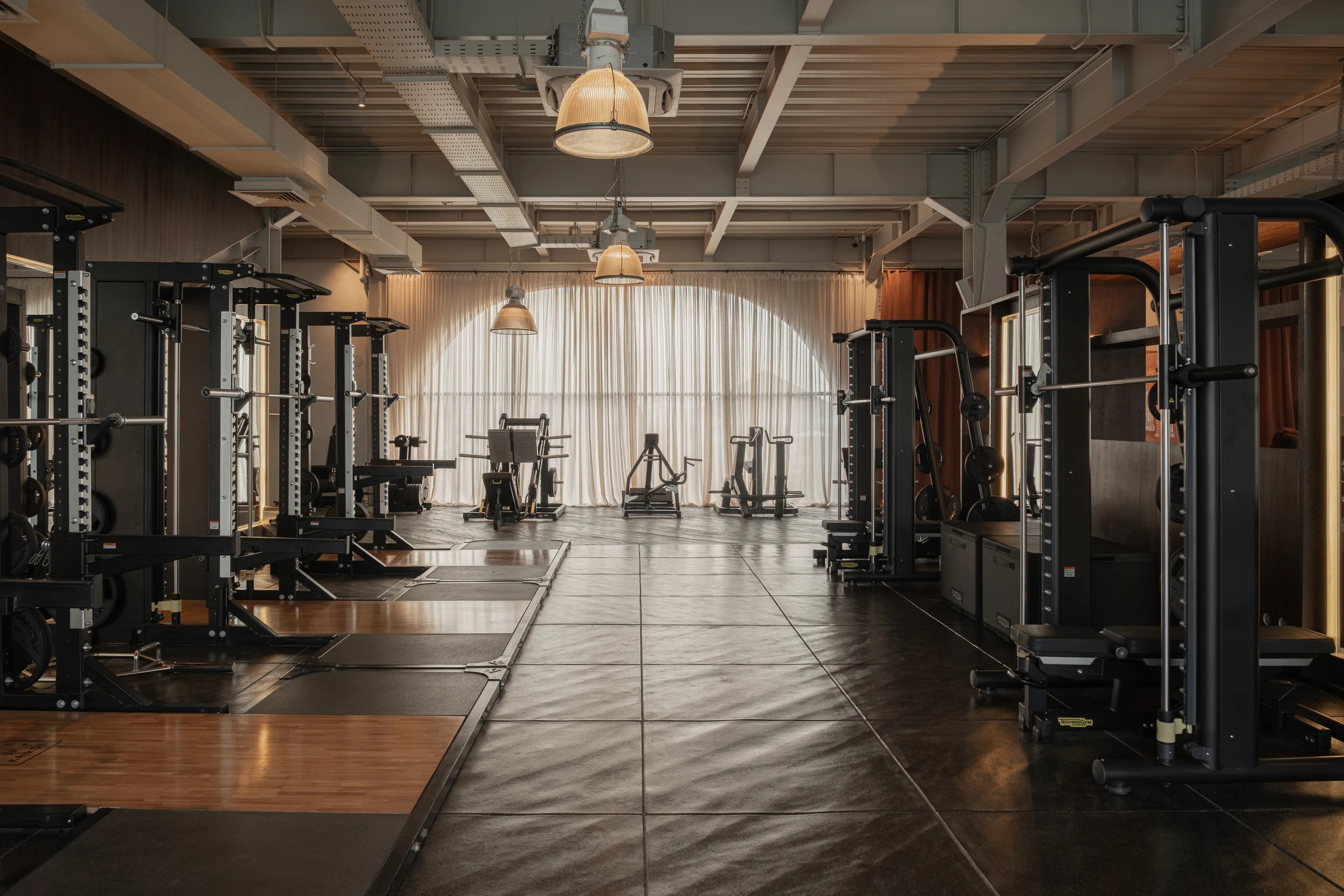 Weight racks and equipment on the gym floor.